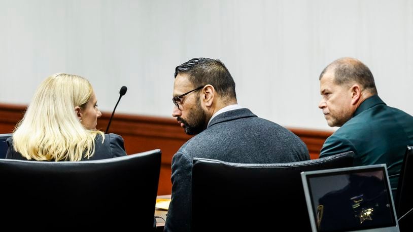 Gurpreet Singh, middle, indicted in the deaths of four family members in 2019 in their West Chester home, sits between his defense attorneys Alex Deardorff and Mark Wieczore for the verdict of his retrial Friday, May 10, 2024 in Butler County Common Pleas Court in Hamilton. Singh was found guilty of all counts by a three-judge panel.  NICK GRAHAM/STAFF