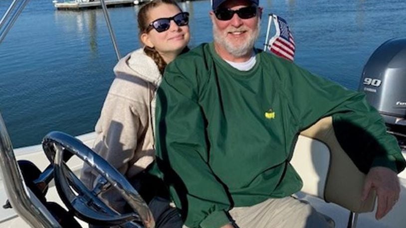 Butler County Common Pleas Judge Greg Howard behind the wheel of his boat in South Carolina with stepdaughter Lorena Reich. SUBMITTED