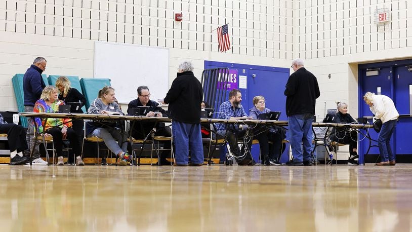 Poll workers check in voters on election day Tuesday, March 19, 2024 at Creekview Elementary School in Middletown. NICK GRAHAM/STAFF
