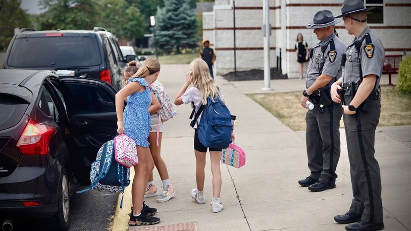 Members of the Ohio State Highway Patrol guard Snowhill Elementary in Springfield as students arrive Tuesday, September 17, 2024. MARSHALL GORBY \STAFF