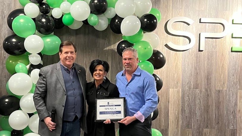 Christine Austin, and her husband Stephen (center and right) celebrate the grand re-opening of their workout studio, SPENGA. They are seen here with Joe Hinson, president and CEO of the West Chester-Liberty Chamber Alliance. CONTRIBUTED