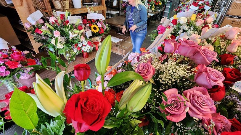 Amanda Reed organizes outgoing Valentine's Day flower orders at Flowers By Roger in Middletown. NICK GRAHAM/STAFF