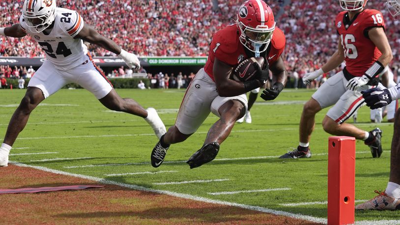 Georgia running back Trevor Etienne (1) is forced out of bounds by Auburn's Keyron Crawford (24) short of the end zone after making a catch in the first half of an NCAA college football game Saturday, Oct. 5, 2024, in Athens, Ga. (AP Photo/John Bazemore)