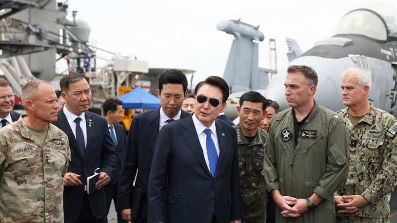 FILE - South Korean President Yoon Suk Yeol, center, boards the USS Theodore Roosevelt aircraft carrier at the South Korean naval base in Busan, South Korea, June 25, 2024. (South Korean Presidential Office/Yonhap via AP, File)