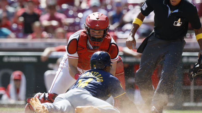 Cincinnati Reds catcher Tyler Stephenson, top left, tags out Milwaukee Brewers' Andruw Monasterio, bottom left, during the 10th inning of a baseball game Sunday, Sept. 1, 2024, in Cincinnati. (AP Photo/Jay LaPrete)