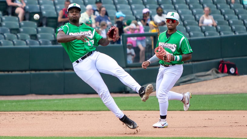 Dragons third baseman Cam Collier fires the baseball to first base while shortstop Victor Acosta backs him up Sunday at Day Air Ballpark. Jeff Gilbert/CONTRIBUTED