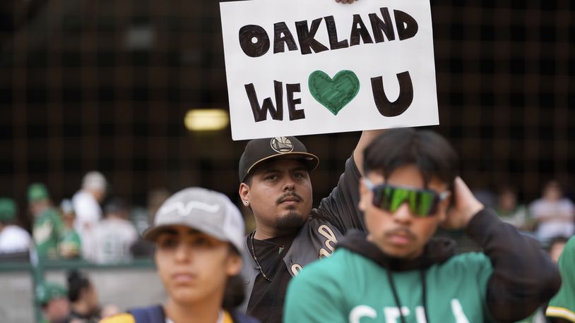 An Oakland Athletics fan holds up a sign before a baseball game against the Texas Rangers, Thursday, Sept. 26, 2024, in Oakland, Calif. (AP Photo/Godofredo A. Vásquez)