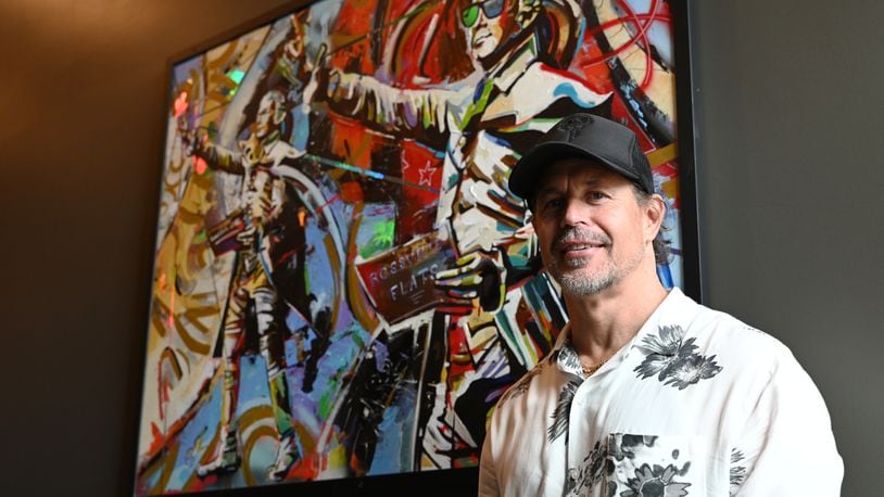 Kentucky-based artist Shawn Voelker created five unique pieces of artwork for the lobby of Rossville Flats which opened near the end of 2023 on Main Street in Hamilton. Pictured is Voelker in front of the piece inspired by The American Cape, the statue of Alexander Hamilton on High Street. MICHAEL D. PITMAN/STAFF