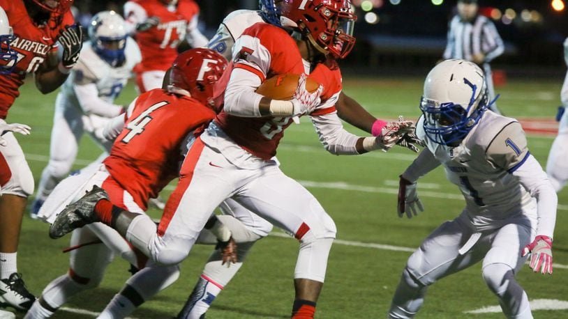 Hamilton’s Johnny Jones (1) prepares to put a hit on Fairfield slotback Chico Robinson (9) during their game at Fairfield Stadium on Oct. 28, 2016. The host Indians won 42-0. GREG LYNCH/STAFF