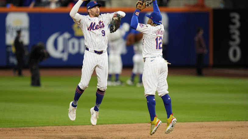 New York Mets shortstop Francisco Lindor (12) and outfielder Brandon Nimmo (9) celebrate after defeating the Philadelphia Phillies in Game 3 of the National League baseball playoff series, Tuesday, Oct. 8, 2024, in New York. (AP Photo/Seth Wenig)