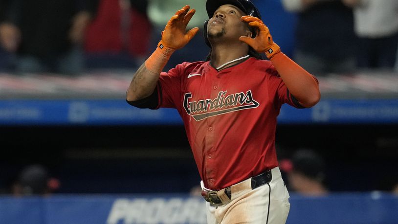 Cleveland Guardians' Jose Ramirez gestures skyward as he approaches home plate after hitting a home run in the eighth inning of a baseball game against the Cincinnati Reds in Cleveland, Wednesday, Sept. 25, 2024. (AP Photo/Sue Ogrocki)