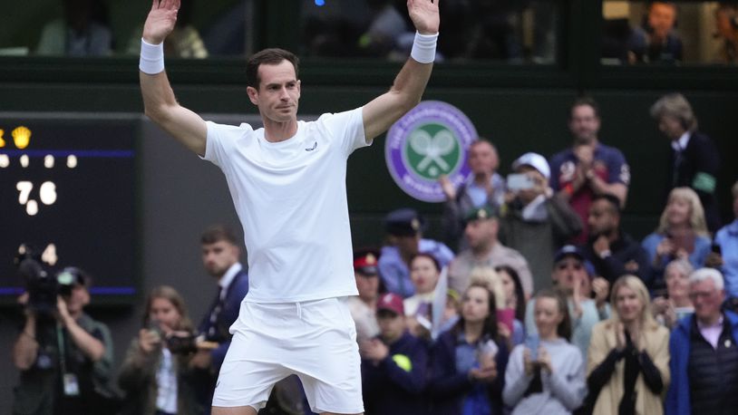 Britain's Andy Murray waves to the Center Court crowd as he leaves following his first round doubles loss at the Wimbledon tennis championships in London, Thursday, July 4, 2024. (AP Photo/Kirsty Wigglesworth)