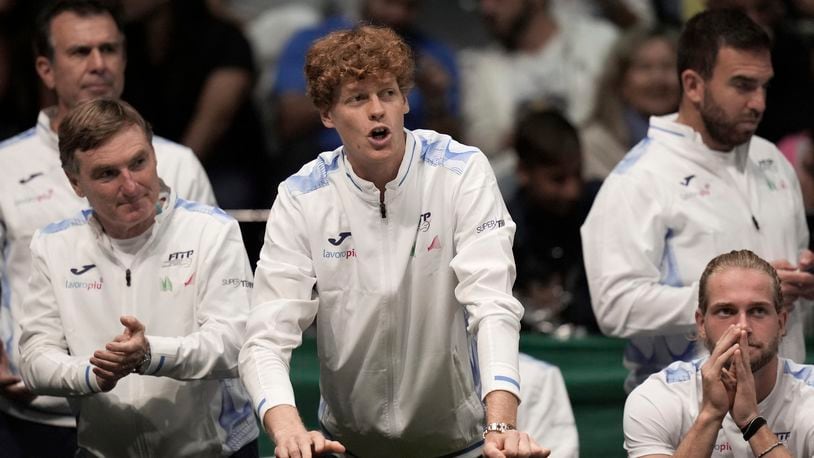 Italy's Jannick Sinner, center, shouts indications to Italy's Matteo Berrettini during a men's singles tennis Davis Cup tennis match between Berrettini and Botic Van Zandschulp of the Netherlands, at the Unipol arena, in Bologna, Italy, Sunday, Sept. 15, 2024. (Michele Nucci/LaPresse via AP)