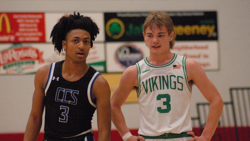 Cincinnati Christian senior Corey Rogers and New Miami sophomore Dalson Hayes chat it up during their Division IV sectional contest on Monday night at Princeton. CCS won 67-29. Chris Vogt/CONTRIBUTED