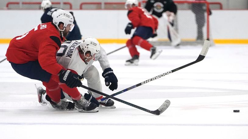 Florida Panthers defenseman Aaron Ekblad (5) and left wing Matthew Tkachuk (19) battle for the puck during NHL hockey training camp Thursday, Sept. 19, 2024, in Fort Lauderdale, Fla. (AP Photo/Lynne Sladky)