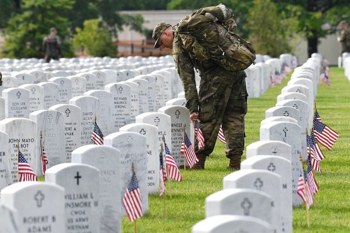 Soldiers place flags at Arlington National Cemetery for Memorial Day