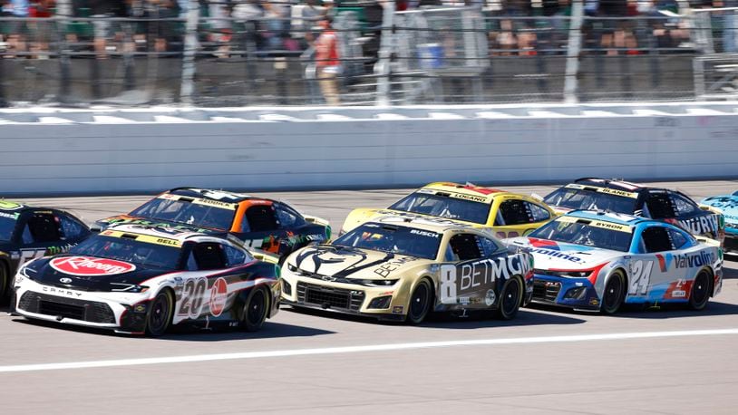 Christopher Bell (20), Kyle Busch (8), William Byron (24), Tyler Reddick (45), Joey Logano (22) and Ryan Blaney (12) head down the front straightaway after a caution flag during a NASCAR Cup Series auto race at Kansas Speedway in Kansas City, Kan., Sunday, Sept. 29, 2024. (AP Photo/Colin E. Braley)