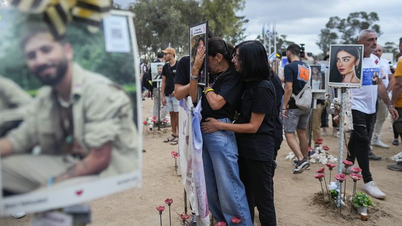 People visit the site of the Nova music festival, where hundreds of revelers were killed and abducted by Hamas and taken into Gaza, on the one-year anniversary of the attack, near Kibbutz Reim, southern Israel, Monday, Oct. 7, 2024. (AP Photo/Ohad Zwigenberg)