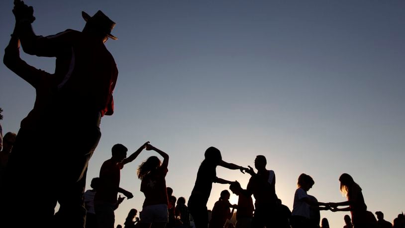 FILE - Tailgaters dance the cajun two step to the Gino Delafose and French Rockin' Boogie zydeco band as a kickoff for the annual Festival Acadiens et Creoles in Lafayette, La., Oct. 8, 2010. (AP Photo/Gerald Herbert, File)