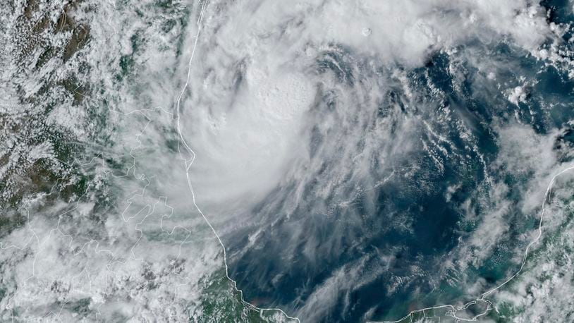 This GOES-16 GeoColor satellite image taken at 4:50 p.m. EDT and provided by National Oceanic and Atmospheric Administration (NOAA) shows Tropical Storm Milton, center, off the coast of Mexico in the Gulf of Mexico, Saturday, Oct. 5, 2024. (NOAA via AP)