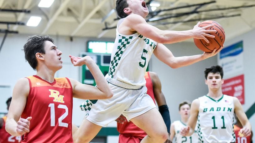 Badin’s Donovan Watkins puts up a shot defended by Purcell Marian’s Jared Baldock during Friday night’s game at Mulcahey Gym in Hamilton. Purcell won 64-52. NICK GRAHAM/STAFF