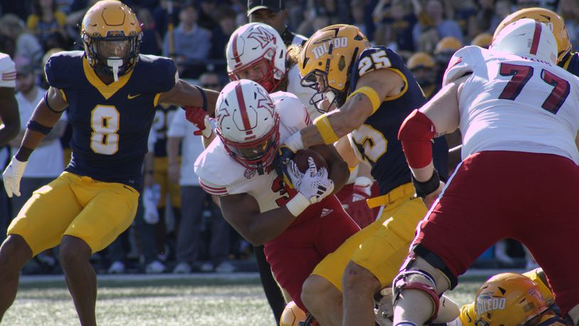 Keyon Mozee holds onto the ball while getting tackled against Toledo on Oct. 5. Kasey Turman/CONTRIBUTED