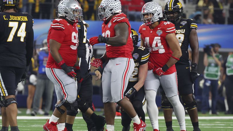 Ohio State defensive tackle Ty Hamilton, middle, celebrates with defensive tackle Tyleik Williams, left, and defensive end JT Tuimoloau (44) after a sack against Missouri during the first half of the Cotton Bowl NCAA college football game Friday, Dec. 29, 2023, in Arlington, Texas. (AP Photo/Richard W. Rodriguez)