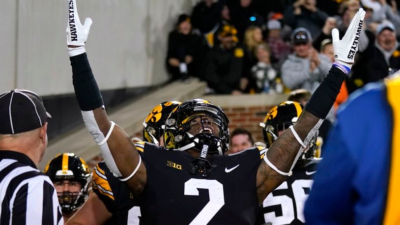 Iowa running back Kaleb Johnson celebrates after scoring on a 30-yard touchdown run in the second half of an NCAA college football game against Illinois, Nov. 18, 2023, in Iowa City, Iowa. Johnson, a Hamilton High School product, rushed for 113 yards and two TDs in Iowa's season-opening win over Illinois State on Saturday. (AP Photo/Charlie Neibergall)