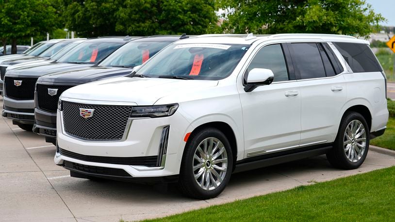 FILE - Unsold 2024 Escalade utility vehicles are parked at a Cadillac dealership on June 2, 2024, in Lone Tree, Colo. (AP Photo/David Zalubowski, File)