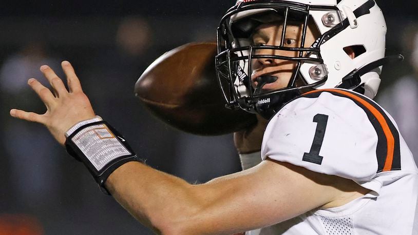 Waynesville's Alex Amburgy throws a pass during Friday's playoff game against Valley View.. BILL LACKEY/STAFF