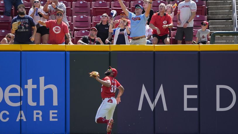 Cincinnati Reds right fielder Amed Rosario watches as a solo home run hit by Atlanta Braves' Matt Olson heads into the stands during the second inning of a baseball game, Thursday, Sept. 19, 2024, in Cincinnati. (AP Photo/Joshua A. Bickel)