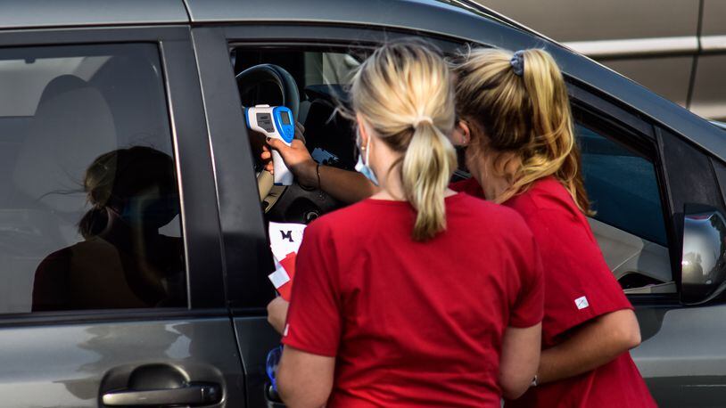 Cars line up for Covid-19 testing before students move in to dorms at Miami University Monday, Sept. 14, 2020 in Oxford. FILE