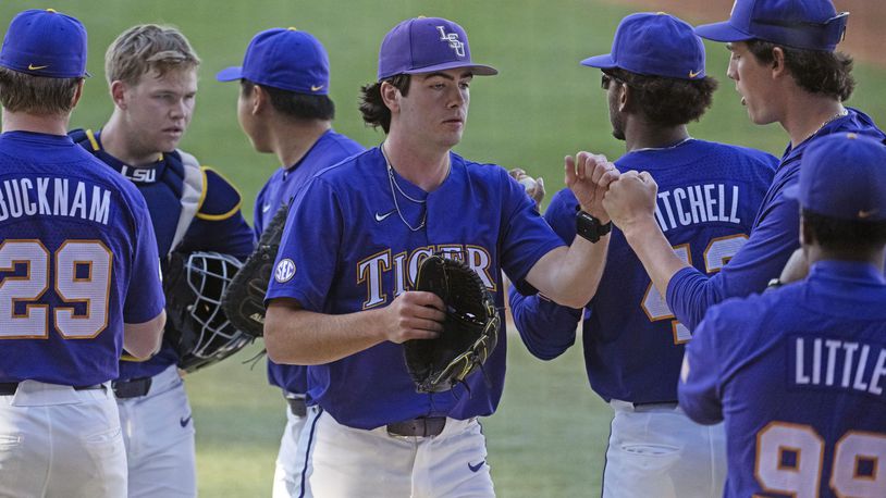 LSU starting pitcher Luke Holman (38) greets his teammates after pitching the first inning against Vanderbilt during an NCAA college baseball game Thursday, April 4, 2024, in Baton Rouge, La. (Hilary Scheinuk/The Advocate via AP)