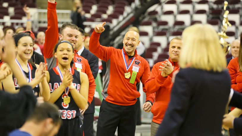 Lakota West girls basketball coach Andy Fishman (center) celebrates with his team after its Division I state championship victory on March 21, 2015, at the Schottenstein Center in Columbus. Lakota West beat Toledo Notre Dame Academy, 44-38. GREG LYNCH/STAFF