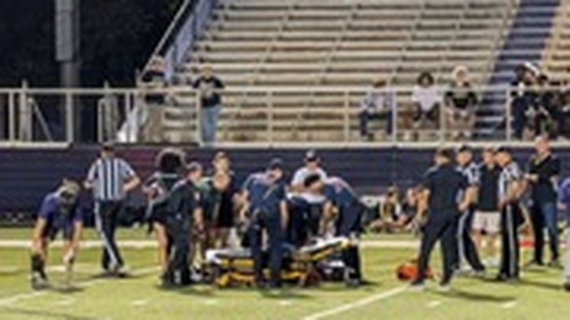 Middletown and Sycamore high school trainers and Middletown EMS members cared for a football official, Tim Hunsaker, who was hit by a player during a Sept. 13 game at Barnitz Stadium. SUBMITTED PHOTO