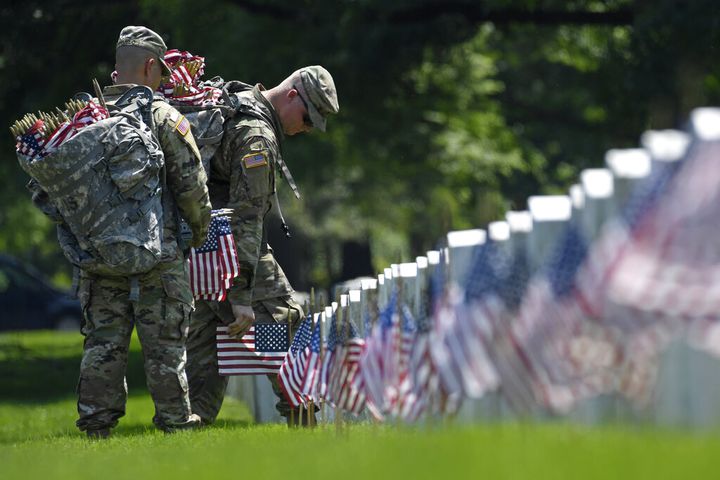 Soldiers place flags at Arlington National Cemetery for Memorial Day