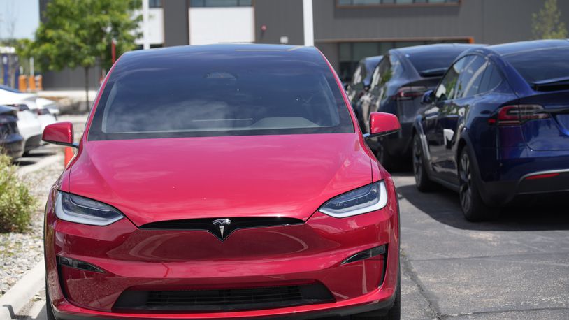 FILE - Unsold 2023 Model X sports-utility vehicles sit at a Tesla dealership, June 18, 2023, in Littleton, Colo. Tesla, the top selling electric vehicle maker in the world, is expected to report a second straight quarter of declining deliveries on Tuesday, July 2, 2024.(AP Photo/David Zalubowski)