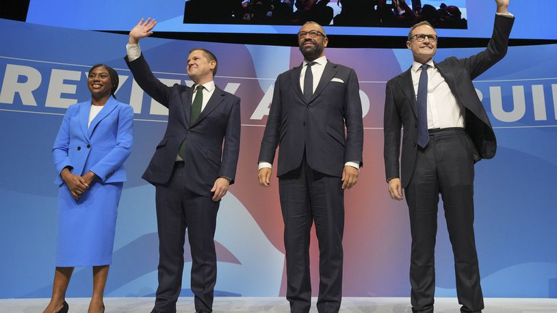 Conservative leadership candidates Kemi Badenoch, from left, Robert Jenrick, James Cleverly and om Tugendhat stand on the podium during the Conservative Party Conference at the International Convention Centre in Birmingham, England, Wednesday, Oct. 2, 2024.(AP Photo/Kin Cheung)