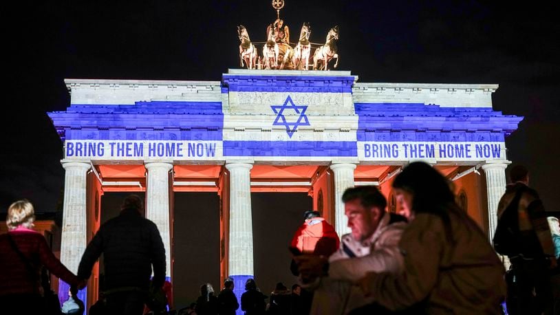 The Brandenburg Gate is illuminated with the flag of Israel in Berlin, Germany, Monday, Oct. 7, 2024, to mark the anniversary of the Hamas attack on Israel on Oct. 7, 2023. (Kay Nietfeld/dpa via AP)