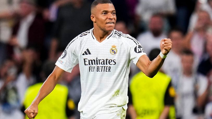 Real Madrid's Kylian Mbappe celebrates after scoring the opening goal during the Champions League opening phase soccer match between Real Madrid and VfB Stuttgart at the Santiago Bernabeu stadium, in Madrid, Tuesday, Sept. 17, 2024. (AP Photo/Manu Fernandez)