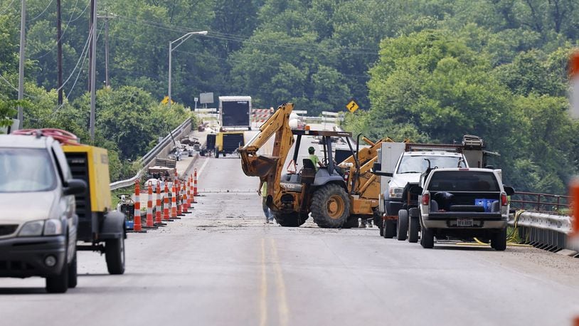 A bridge that links the city to Madison Twp. on Ohio 122 over the Great Miami River is seen Mon., June 13, 2022. Contractors are there to remove debris from the main channel of the river and make bridge repairs. NICK GRAHAM/STAFF