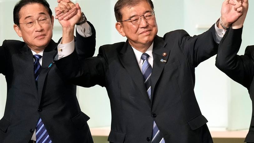 Shigeru Ishiba, right, with Japan's Prime Minister Fumio Kishida, left, and other candidates, celebrates after Ishiba was elected as new head of Japan's ruling Liberal Democratic Party during its leadership election Friday, Sept. 27, 2024, in Tokyo. (AP Photo/Hiro Komae, Pool)