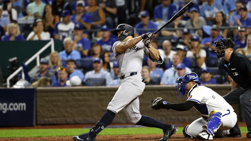 New York Yankees' Giancarlo Stanton hits an RBI double during the fourth inning in Game 3 of an American League Division baseball playoff series against the Kansas City Royals Wednesday, Oct. 9, 2024, in Kansas City, Mo. (AP Photo/Colin Braley)