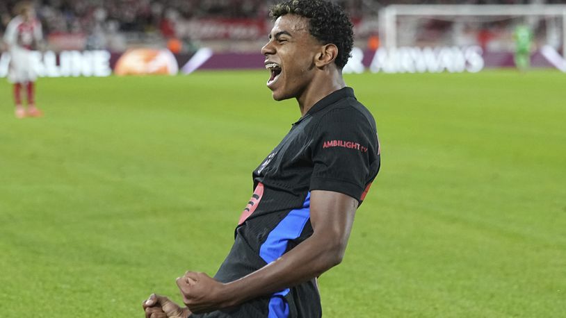 Barcelona's Lamine Yamal celebrates after scoring his side's opening goal during the Champions League opening phase soccer match between Monaco and Barcelona at the Louis II stadium, in Monaco, Monaco, Thursday, Sept. 19, 2024. (AP Photo/Laurent Cipriani)