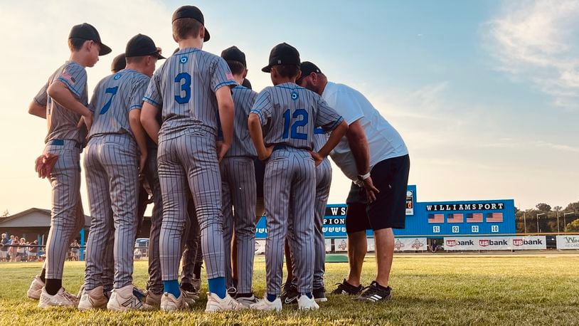 West Side players and coaches gather in a huddle before taking the field against Galion in the Ohio Little League state tournament on Tuesday at West Side Little League. Chris Vogt/CONTRIBUTED