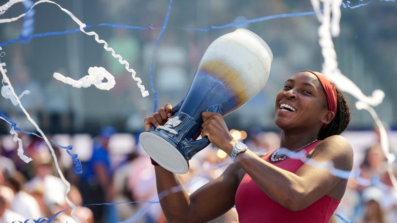 Coco Gauff, of the United States, celebrates with the Rookwood Cup as she poses for photos after defeating Karolina Muchova, of the Czech Republic, during the women's singles final of the Western & Southern Open tennis tournament, Sunday, Aug. 20, 2023, in Mason, Ohio. (AP Photo/Aaron Doster)