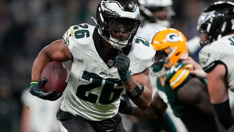 Philadelphia Eagles running back Saquon Barkley (26) runs for a touchdown against the Green Bay Packers during the first half of an NFL football game, Friday, Sept. 6, 2024, at the Neo Quimica Arena in Sao Paulo. (AP Photo/Doug Benc)