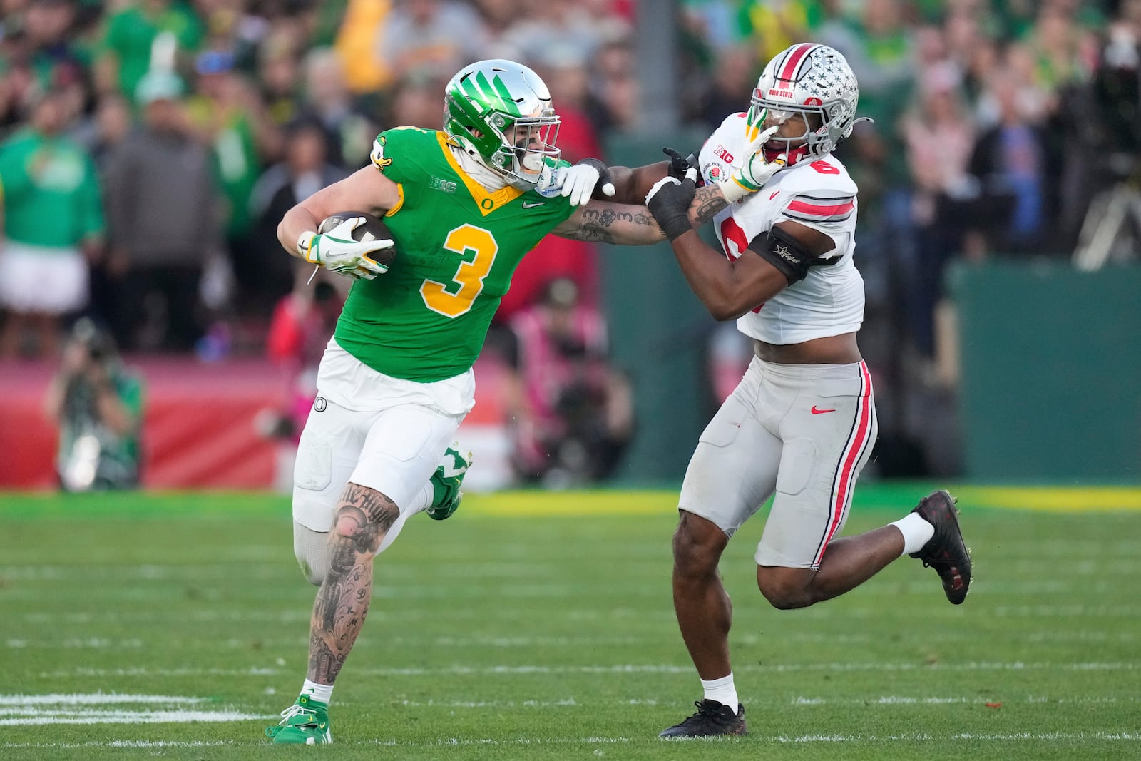 Oregon tight end Terrance Ferguson (3) stiff-arms Ohio State safety Sonny Styles (6) during the second half in the quarterfinals of the Rose Bowl College Football Playoff, Wednesday, Jan. 1, 2025, in Pasadena, Calif. (AP Photo/Mark J. Terrill)