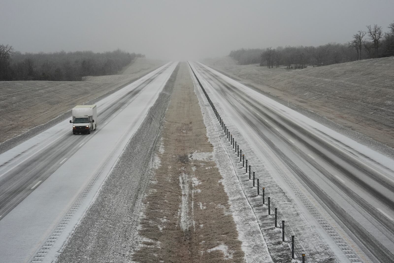 A truck drives along Interstate 335 during a winter storm, Tuesday, Feb. 18, 2025, near Luther, Okla. (AP Photo/Joshua A. Bickel)