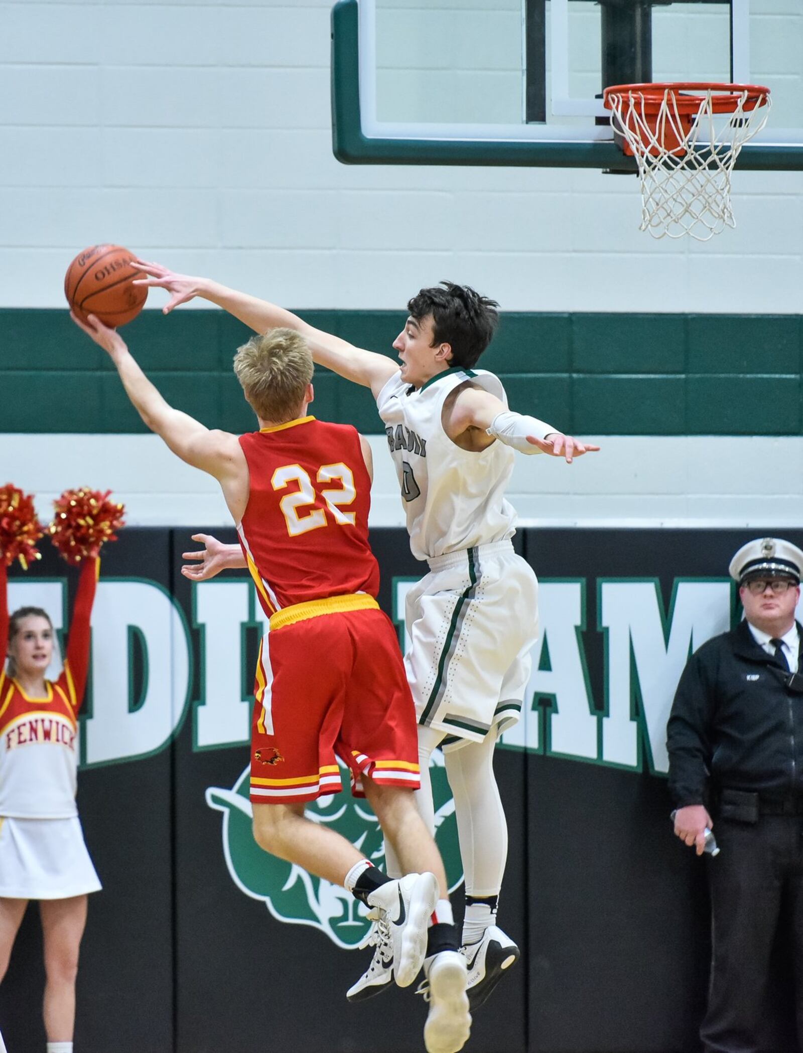 Badin’s Jakob Tipton goes after a shot by Fenwick’s C.J. Napier (22) on Friday night at Mulcahey Gym in Hamilton. NICK GRAHAM/STAFF